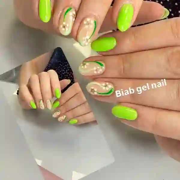 Neon green summer nails with floral accents