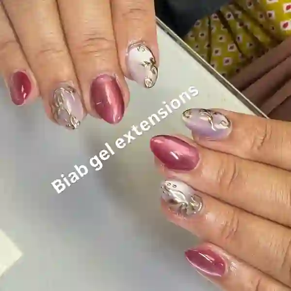 Pink chrome nails with floral detail
